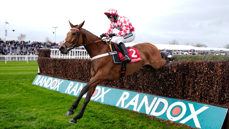 Jango Baie ridden by Nico de Boinville (nearside, red and white silks) on the way to winning the Racing Welfare Bowl Chase at Aintree