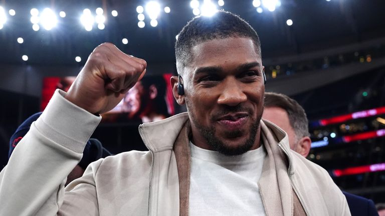 Anthony Joshua waves at fans following Tyson Fury's win over Arslanbek Makhmudov