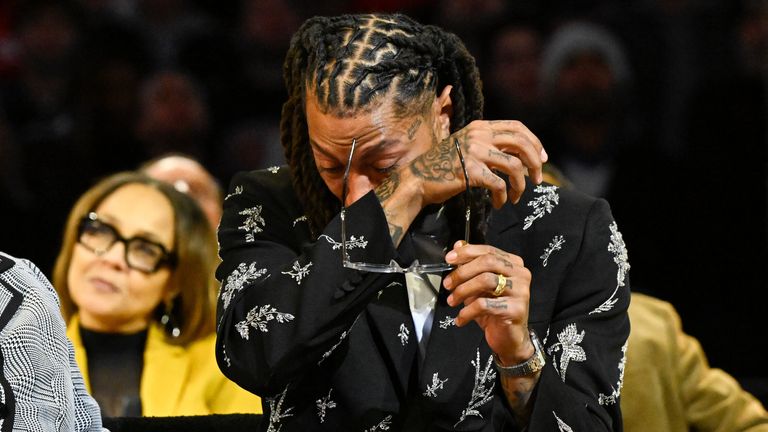 Former Chicago Bulls player Derrick Rose wipes away tears as former team-mates speak during his jersey retirement ceremony