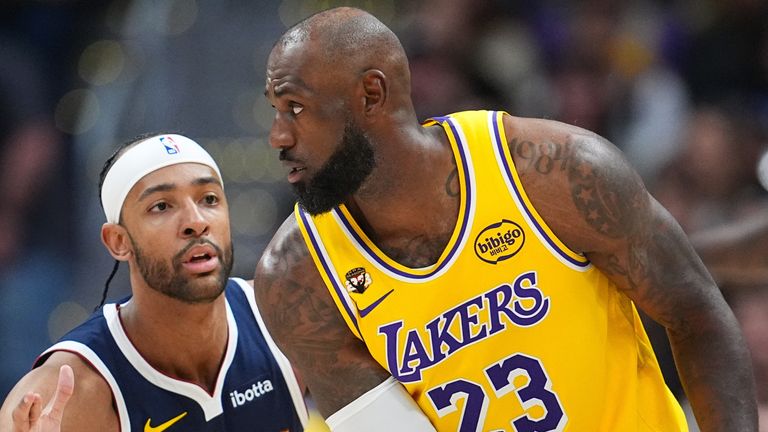 LeBron James looks to pass as Zeke Nnaji defends  (AP Photo/David Zalubowski)
