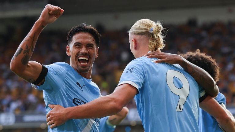 Tijjani Reijnders celebrates with his Man City team-mates at Wolves 