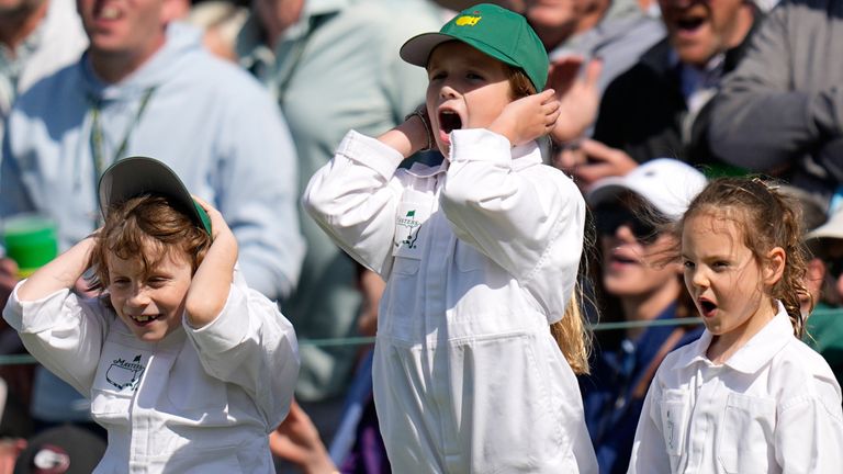 Tommy Fleetwood react to a shot with his son, Franklin, Shane Lowry's daughter, Iris, and Rory McIlroy's daughter, Poppy